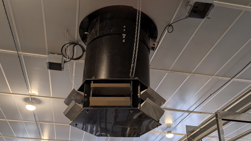 Large black ventilation unit suspended from the ceiling